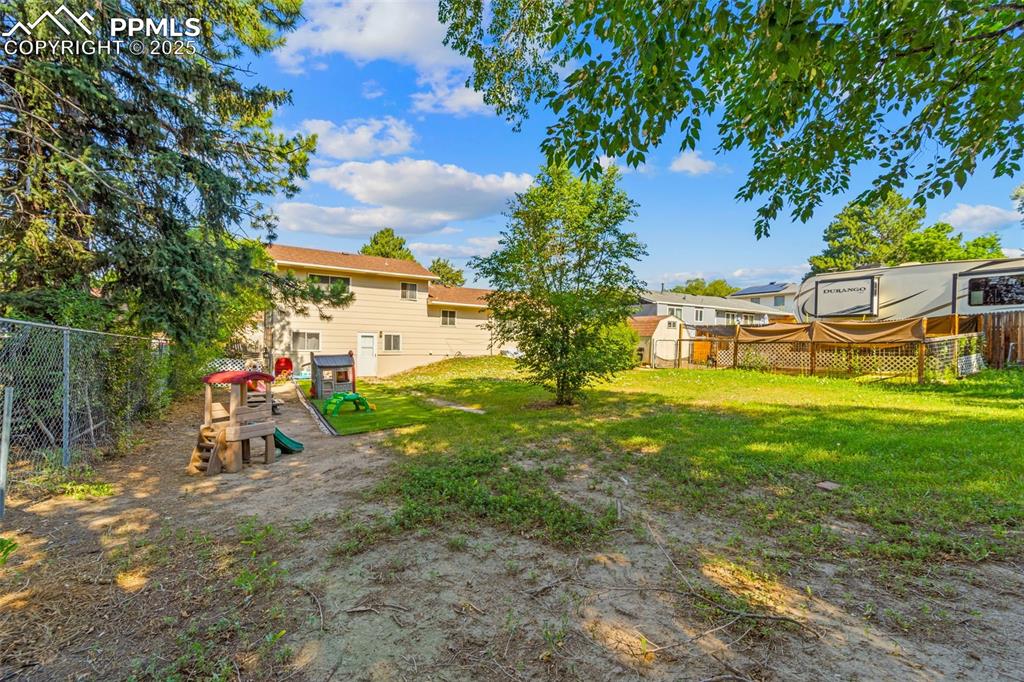 Image 36 of 38: View of yard with a playground