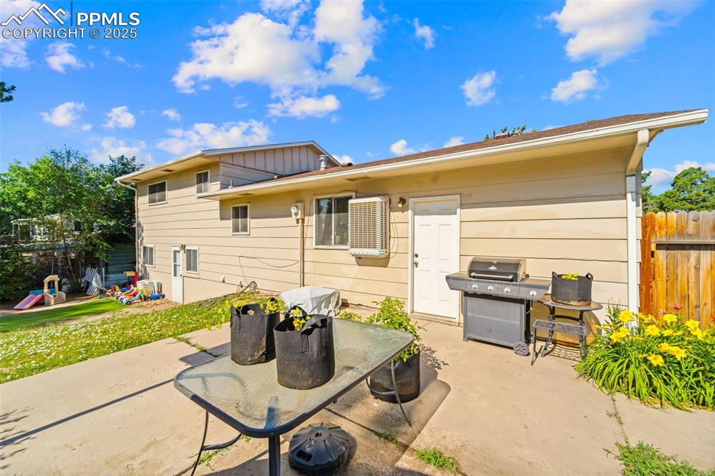 Image 37 of 38: Back of house with a patio area and board and batten siding