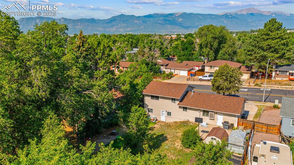 Image 7 of 38: Aerial perspective of suburban area with a mountainous background