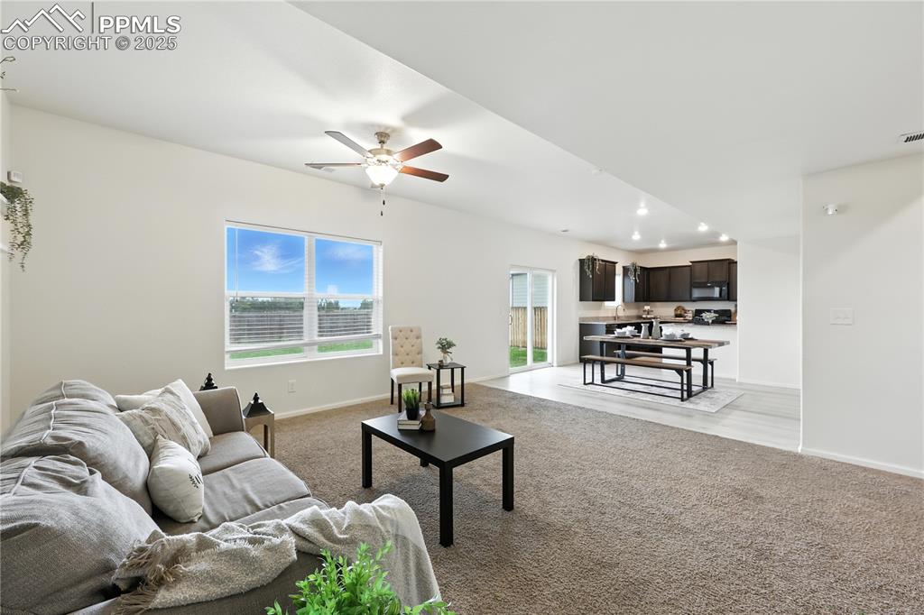 Image 10 of 47: View into the Dining Area and Kitchen from the Living Room.