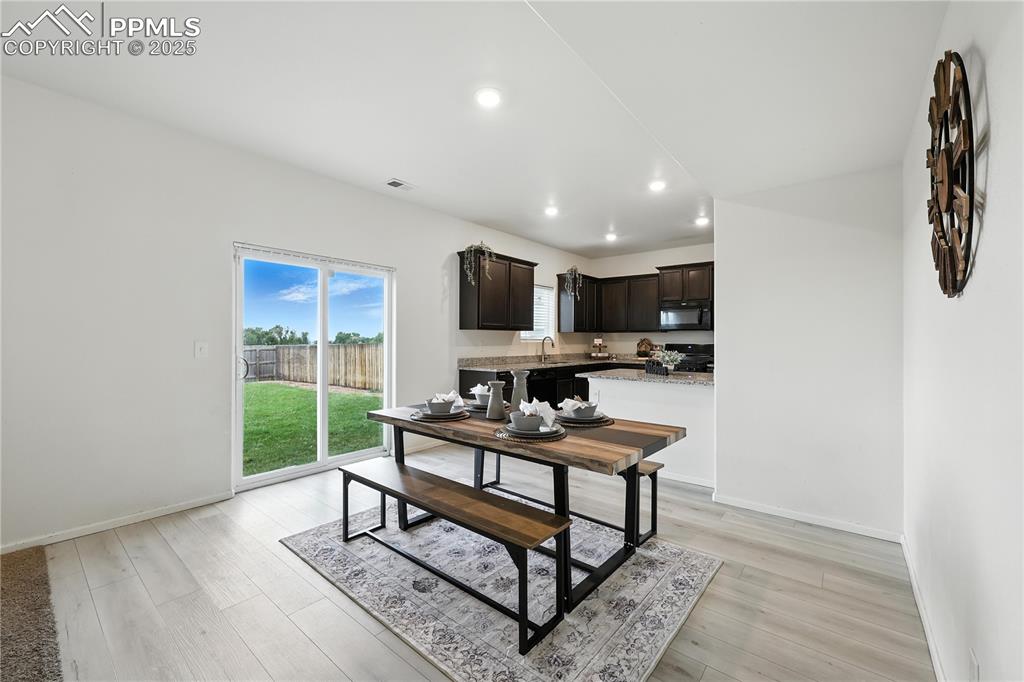 Image 13 of 47: The Dining Area features wood laminate flooring and a slider that opens to