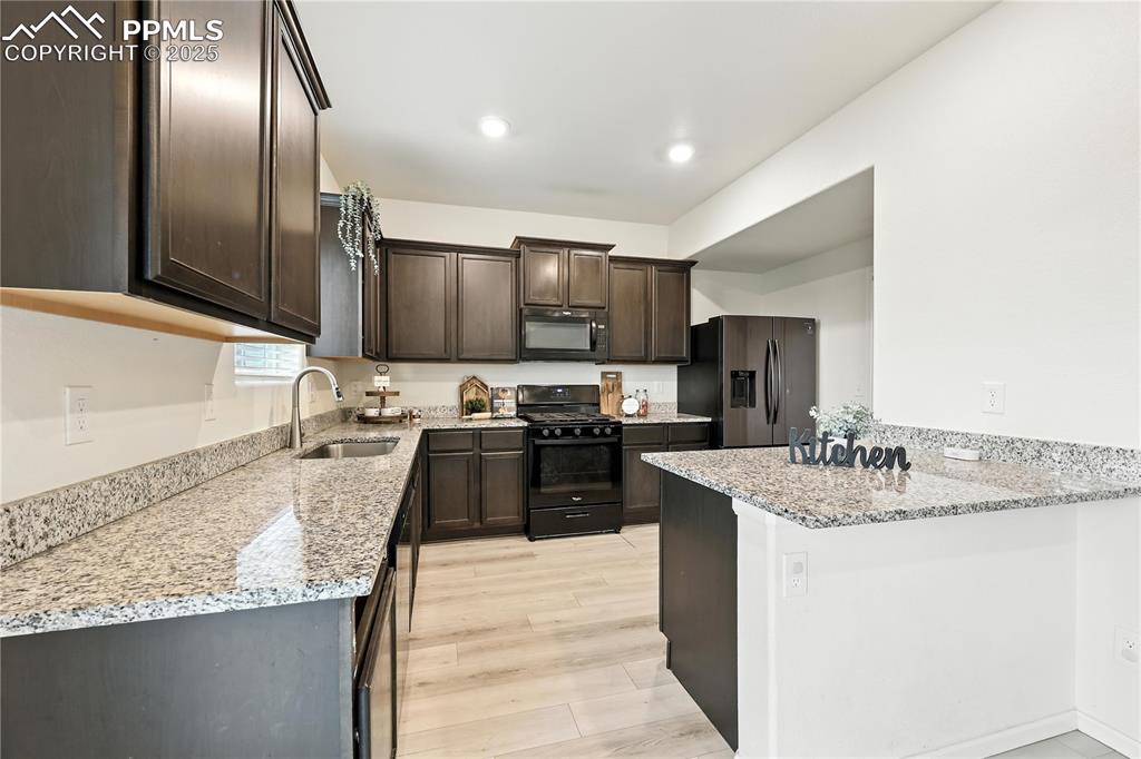 Image 16 of 47: Ample cabinetry and granite countertops for kitchen storage and easy food p