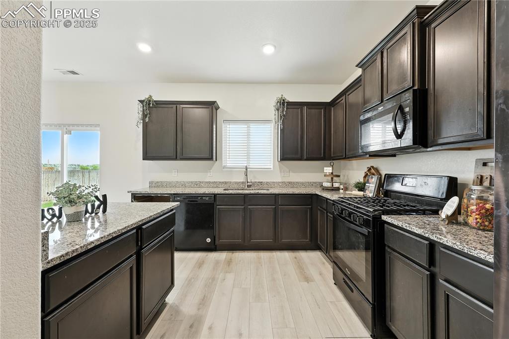 Image 17 of 47: Appliances include a gas range oven, built in microwave, dishwasher, and re