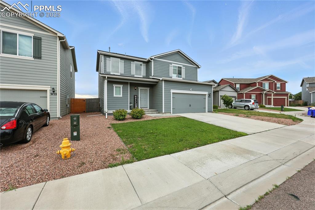 Image 2 of 47: Low maintenance, well manicured front yard with covered porch.