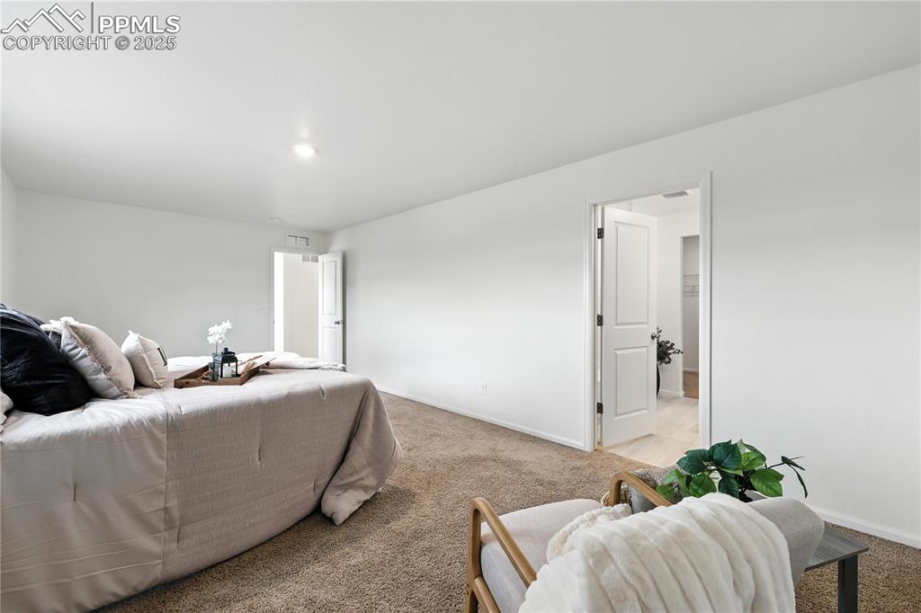 Image 25 of 47: The upper level Primary Suite offers a private sitting area.