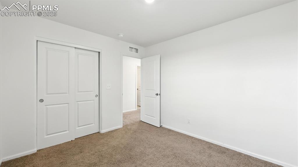 Image 34 of 47: Upper Level Bedroom #2 has a generous closet.