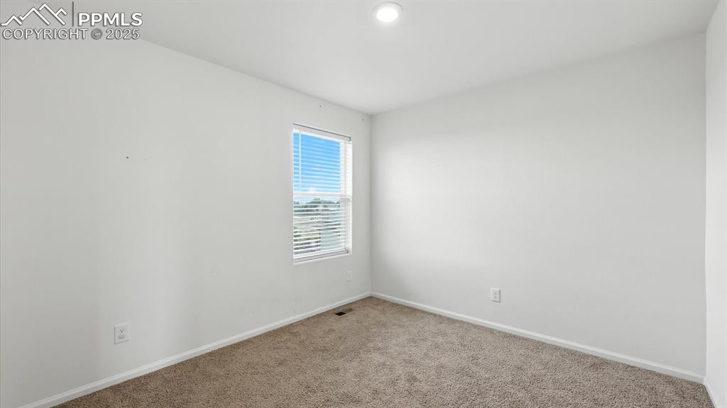 Image 36 of 47: Upper Level Bedroom #3 has neutral carpet.