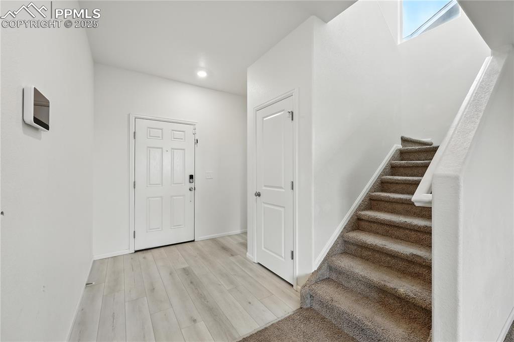 Image 4 of 47: Front Entry with coat closet attractive wood laminate flooring.