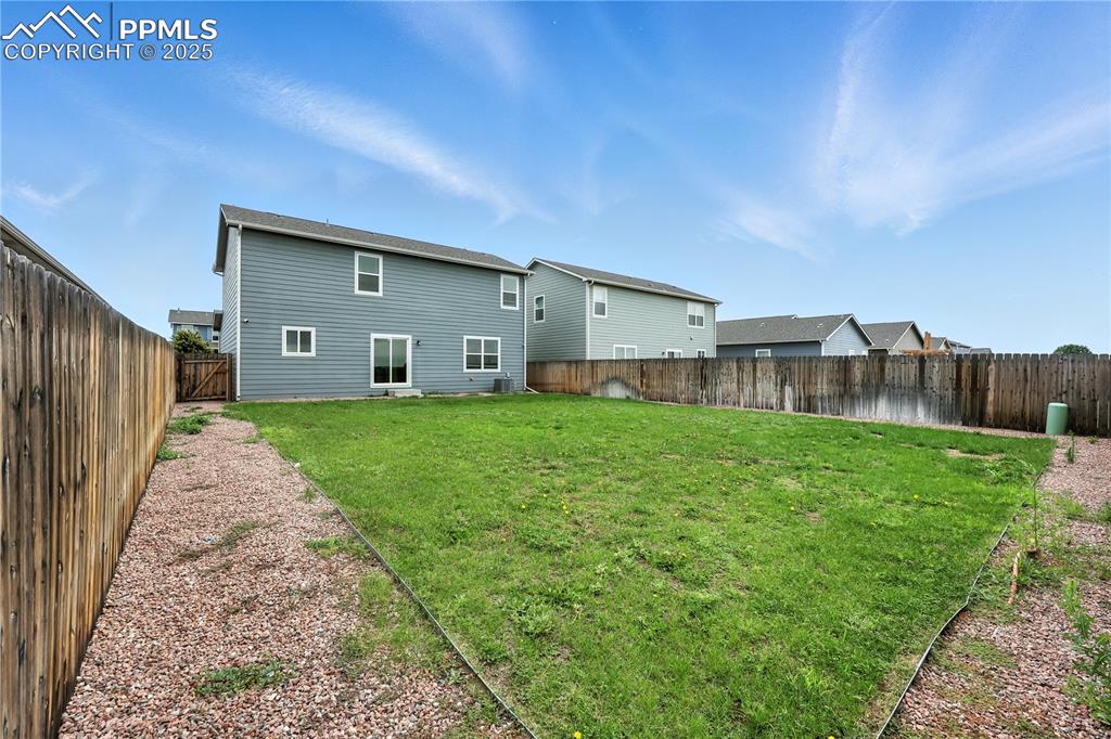 Image 41 of 47: Large fenced backyard for outdoor fun and relaxation.