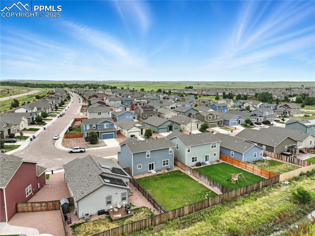 Image 44 of 47: Aerial view of backyard and community.