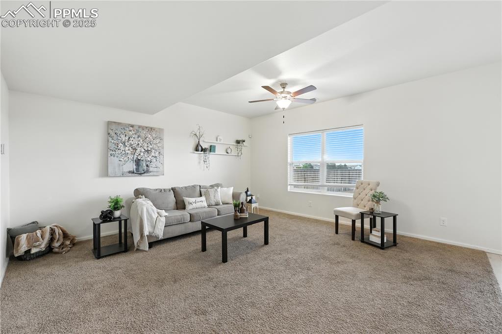 Image 7 of 47: The Living Room, bathed in natural light from the large view window, featur