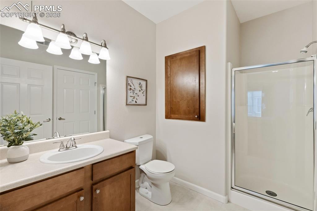 Image 21 of 26: Bathroom featuring vanity and a shower stall