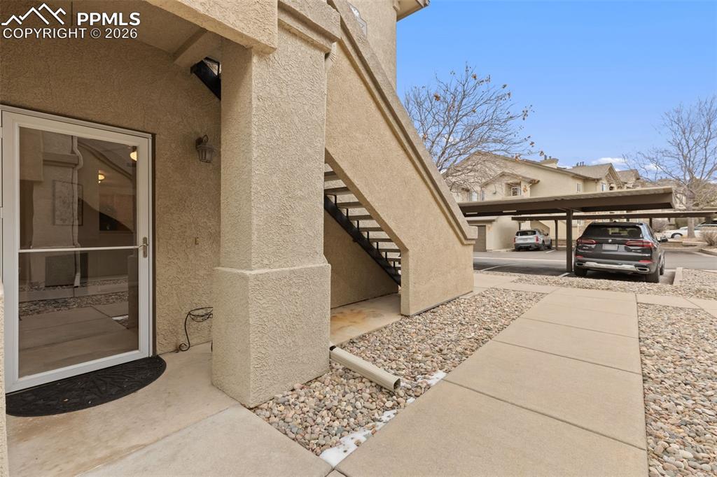 Image 3 of 26: Entrance to property featuring stucco siding