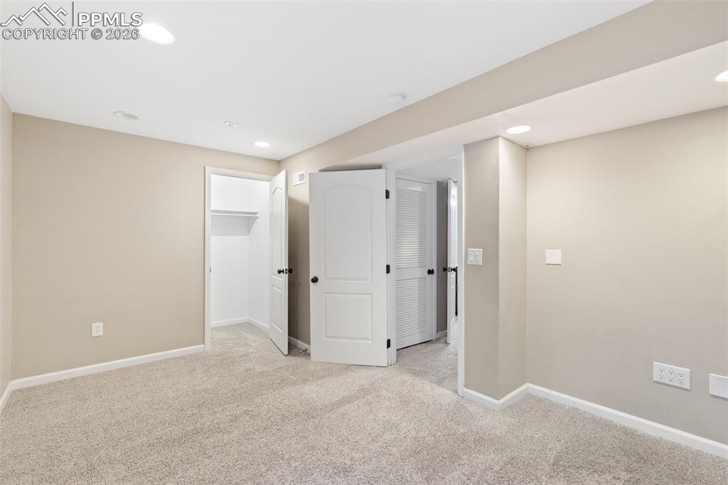 Image 20 of 26: Finished basement boasts a fourth bedroom with large walk-in closet (this r