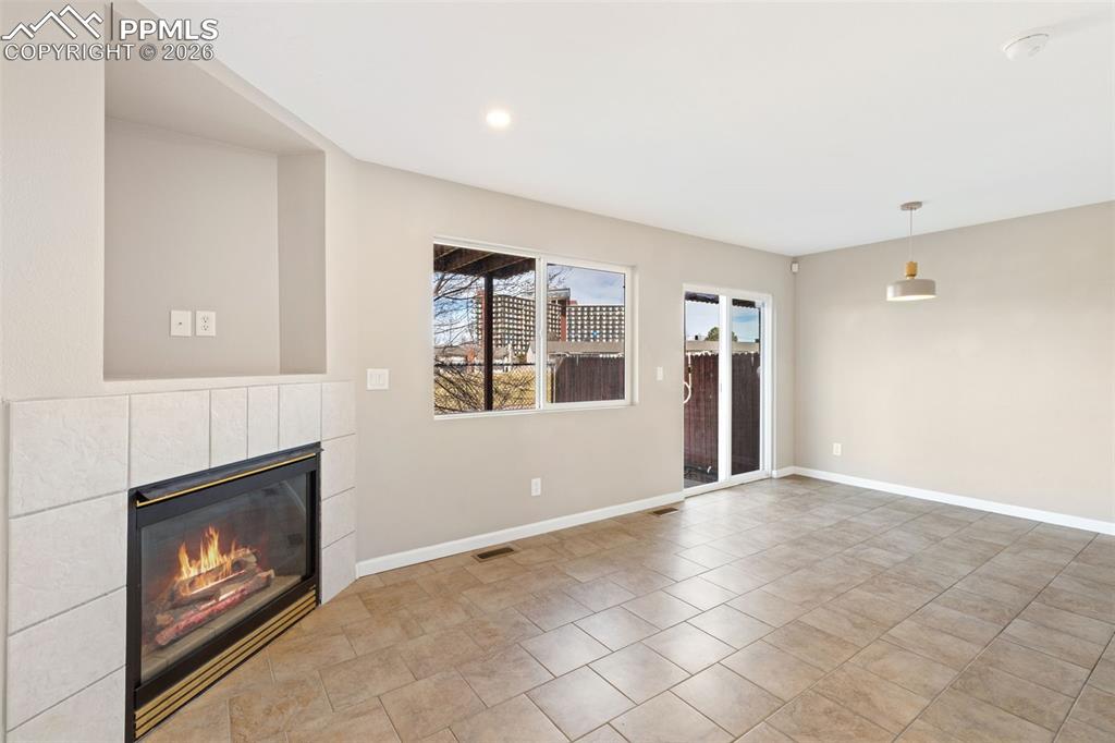 Image 7 of 26: Another view of living room and dining area, and walk-out.