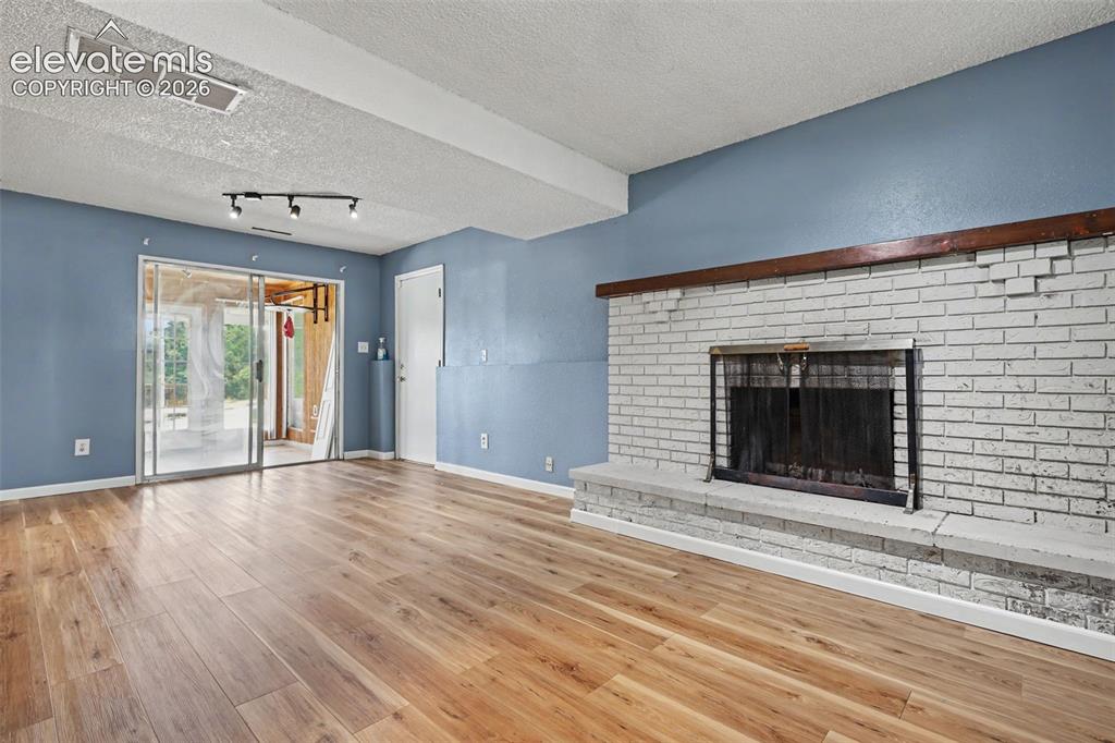 Image 9 of 17: featuring a Wood Burning Fireplace