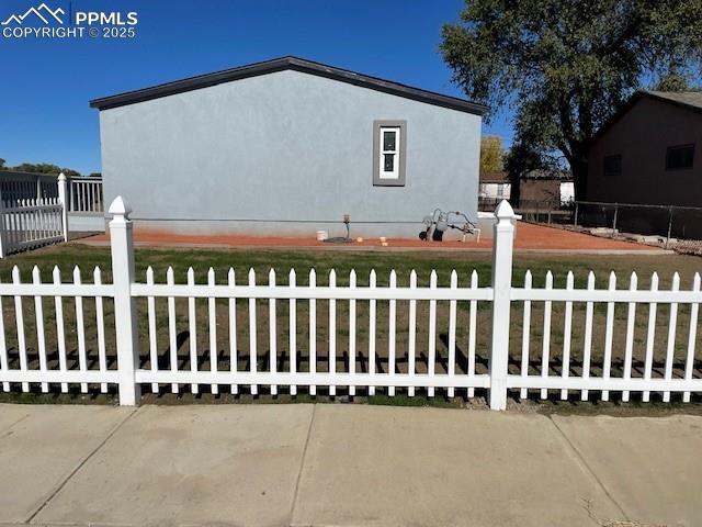 Caption: View of side of home with stucco siding