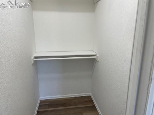 Image 15 of 21: Spacious closet with wood finished floors
