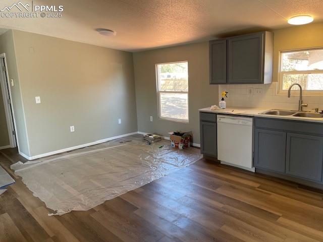 Image 5 of 21: Kitchen with gray cabinets, tasteful backsplash, white dishwasher, a textur