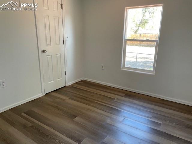 Image 8 of 21: Spare room featuring wood finished floors and baseboards