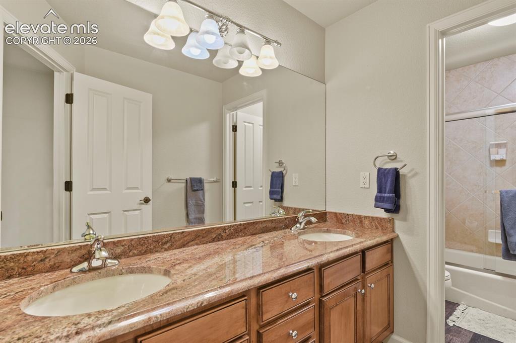 Image 30 of 47: Dual vanity with stone countertop and undermount sinks