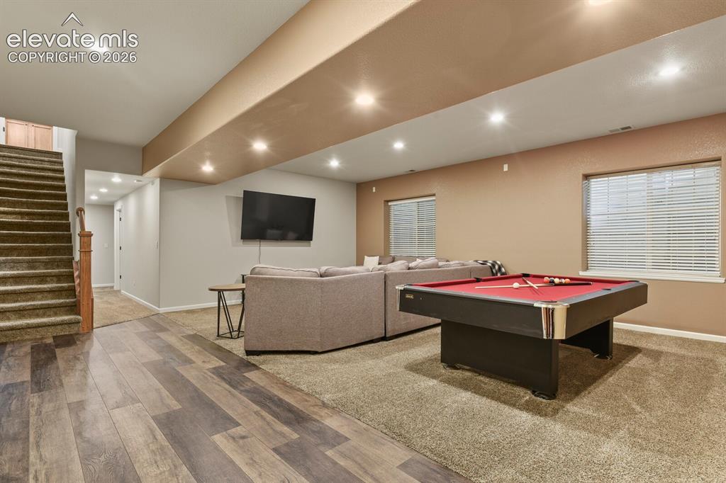Image 36 of 47: Finished lower level featuring a pool table, wood-finish flooring, recessed