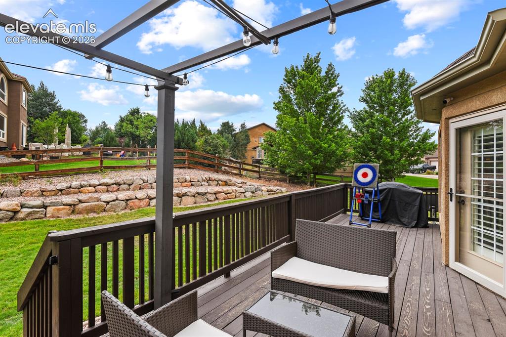 Image 45 of 47: Spacious outdoor deck featuring wood-finish decking and dark railings