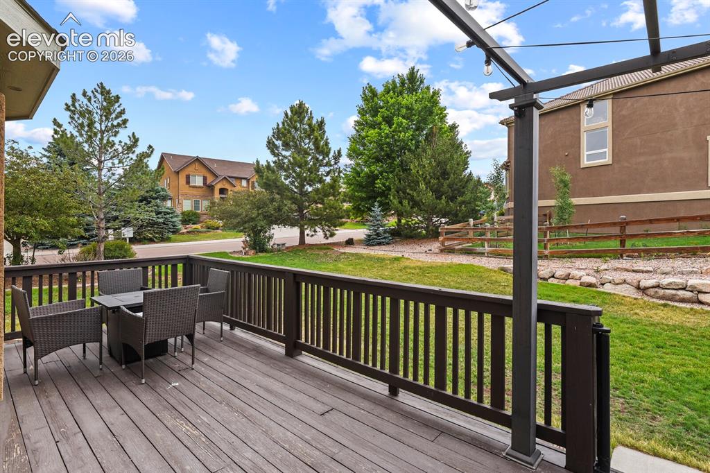 Image 46 of 47: Outdoor deck featuring wood-finish flooring, dark wood railing, and an over