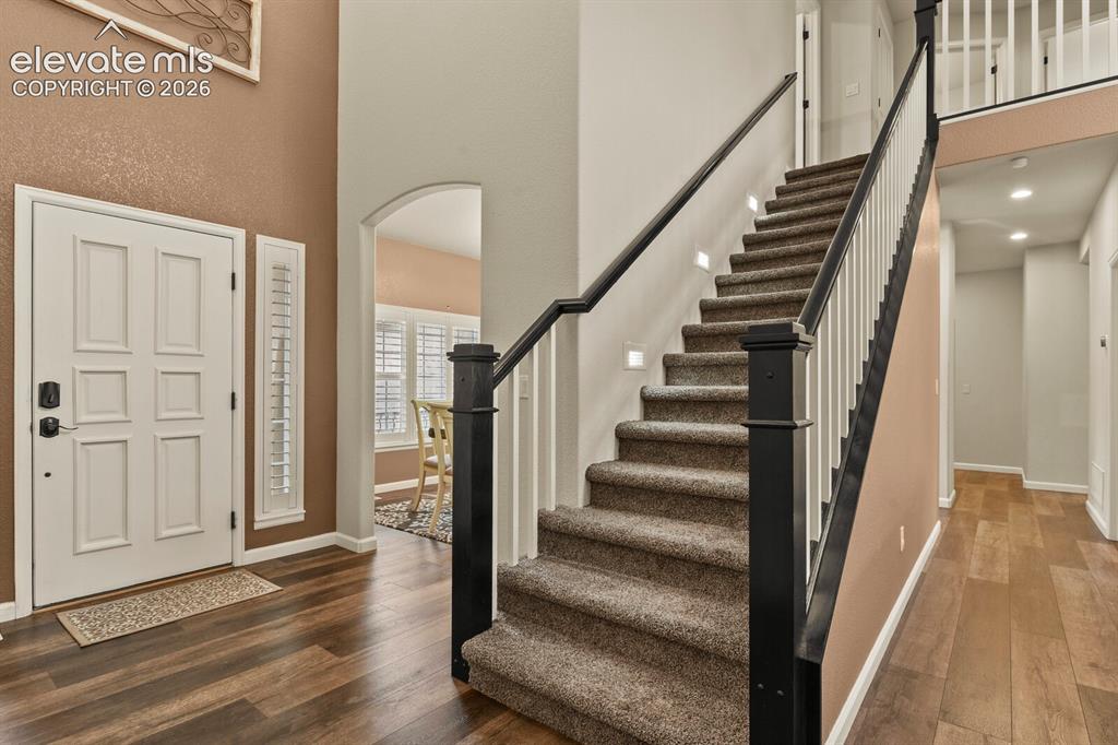 Image 6 of 47: Entryway featuring a paneled door with sidelight, wood-finish flooring, and