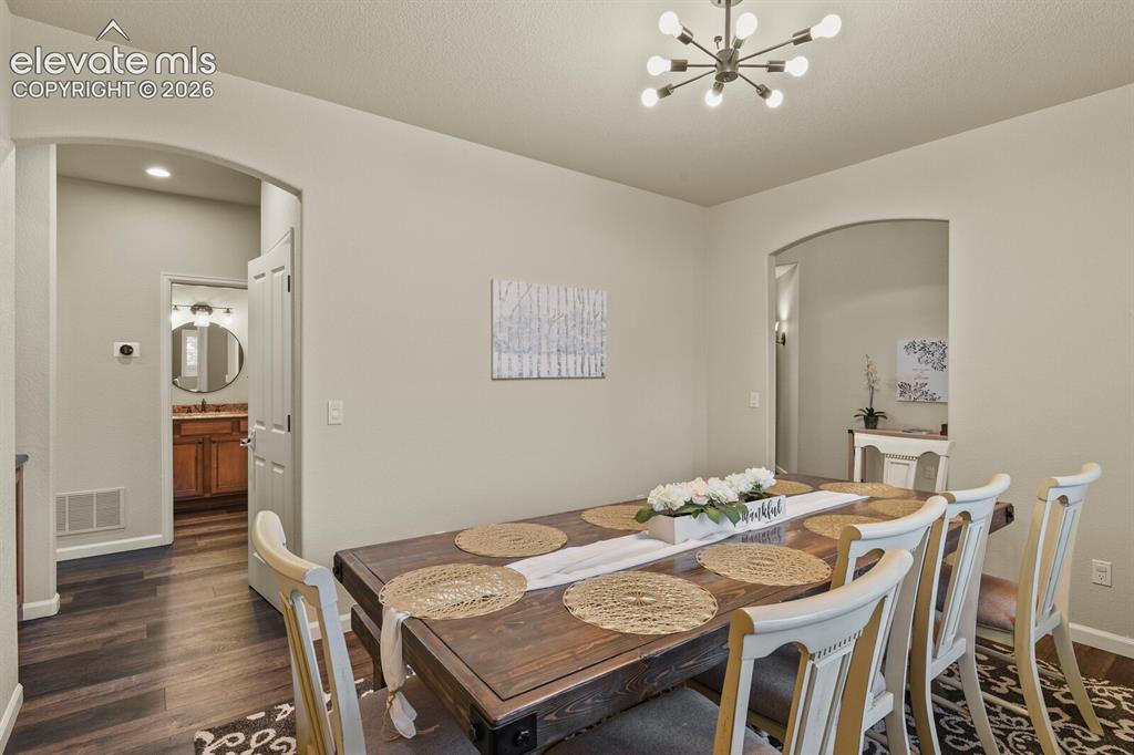 Image 8 of 47: Open concept dining area featuring wood-finish flooring, recessed lighting,