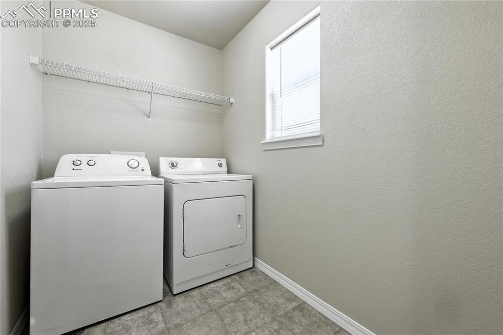 Image 15 of 46: Washroom with separate washer and dryer and baseboards
