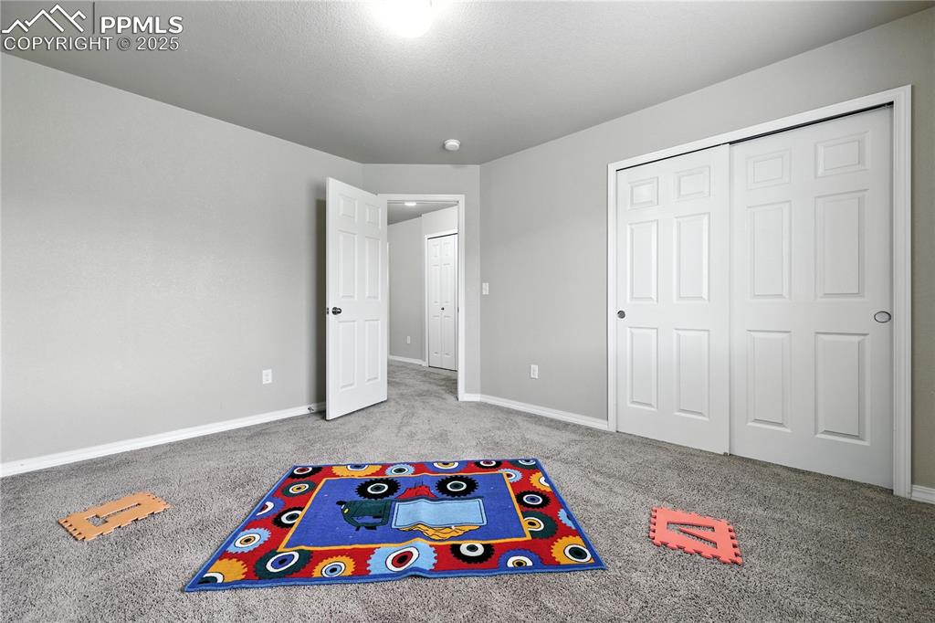 Image 25 of 46: Playroom featuring carpet and baseboards