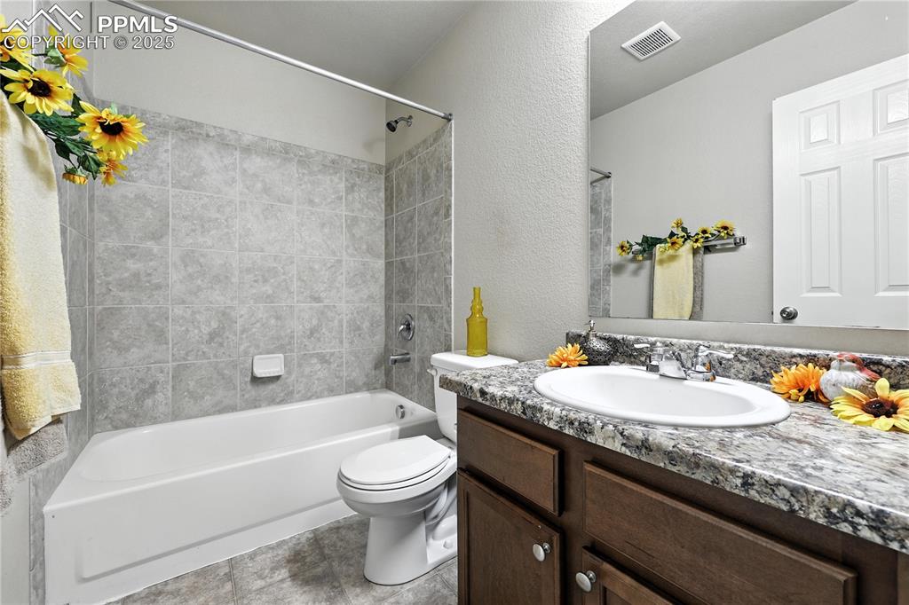 Image 26 of 46: Bathroom with vanity, tub / shower combination, and a textured wall