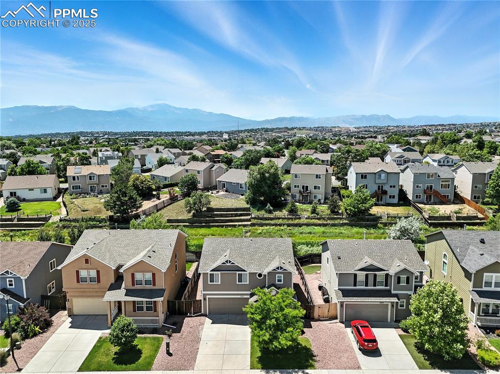 Image 31 of 46: Aerial perspective of suburban area with a mountain backdrop