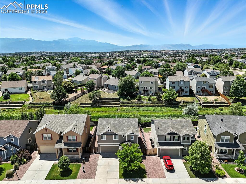Image 34 of 46: Aerial view of residential area with a mountainous background