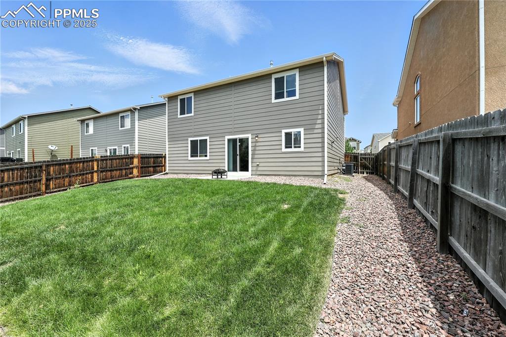 Image 37 of 46: Back of house featuring a fenced backyard