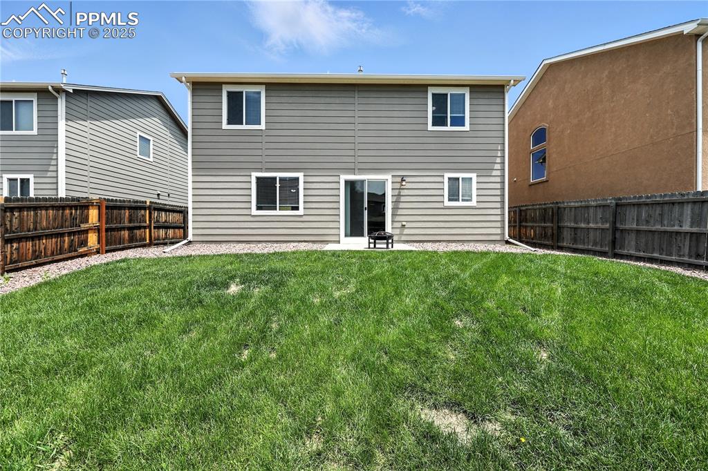 Image 38 of 46: Back of house with a fenced backyard and a patio area