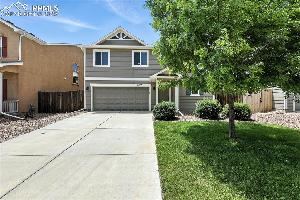 Image 40 of 46: View of front of home featuring concrete driveway and a garage