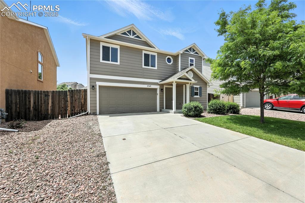 Image 41 of 46: View of front of home with concrete driveway and a garage