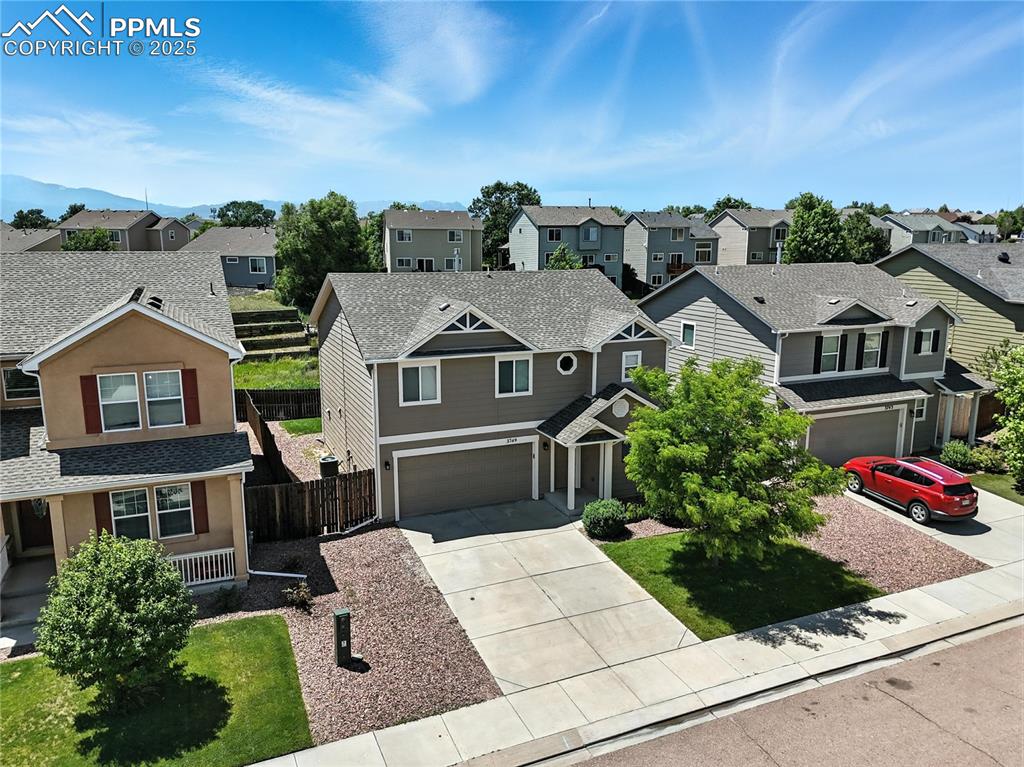 Image 43 of 46: Traditional-style home with a residential view, an attached garage, drivewa