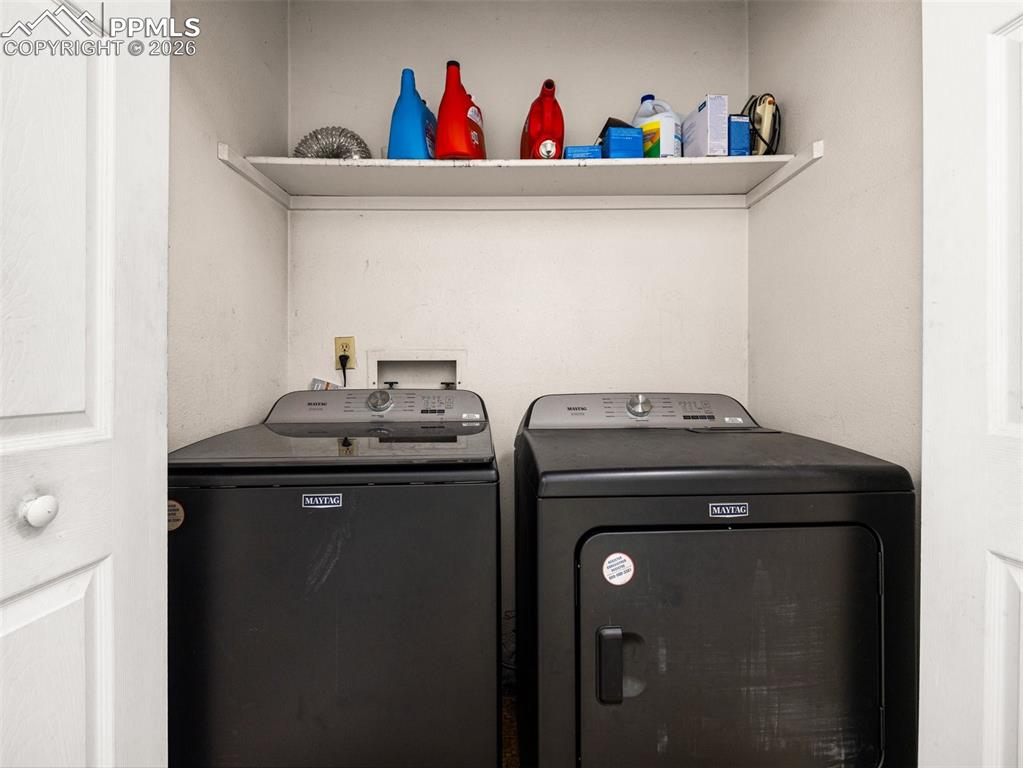 Image 19 of 30: Laundry area featuring separate washer and dryer
