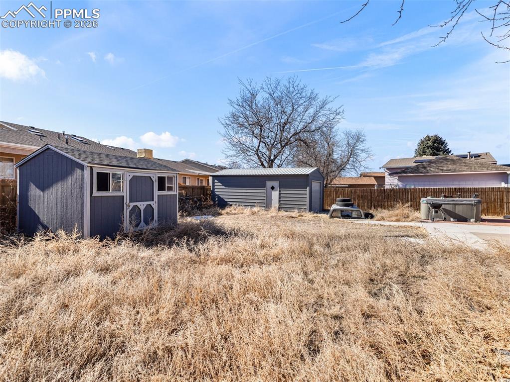 Image 22 of 30: Rear view of property with a storage unit