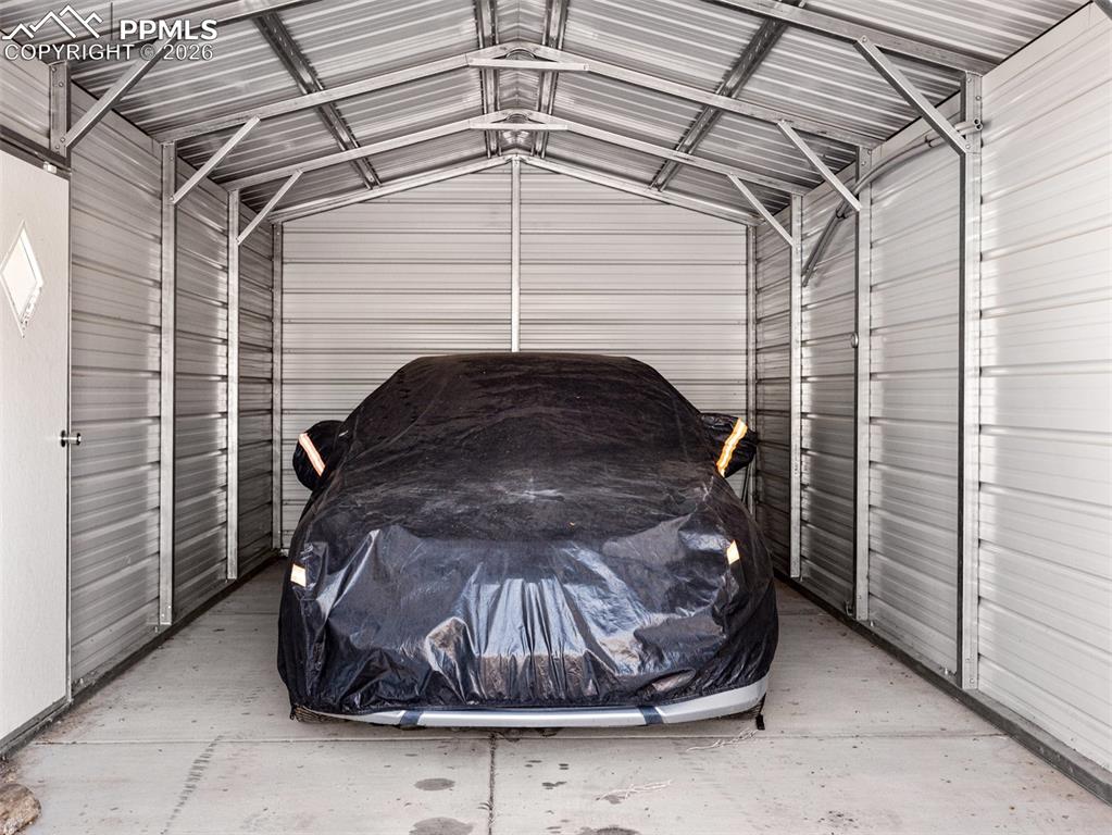Image 25 of 30: Garage featuring metal wall