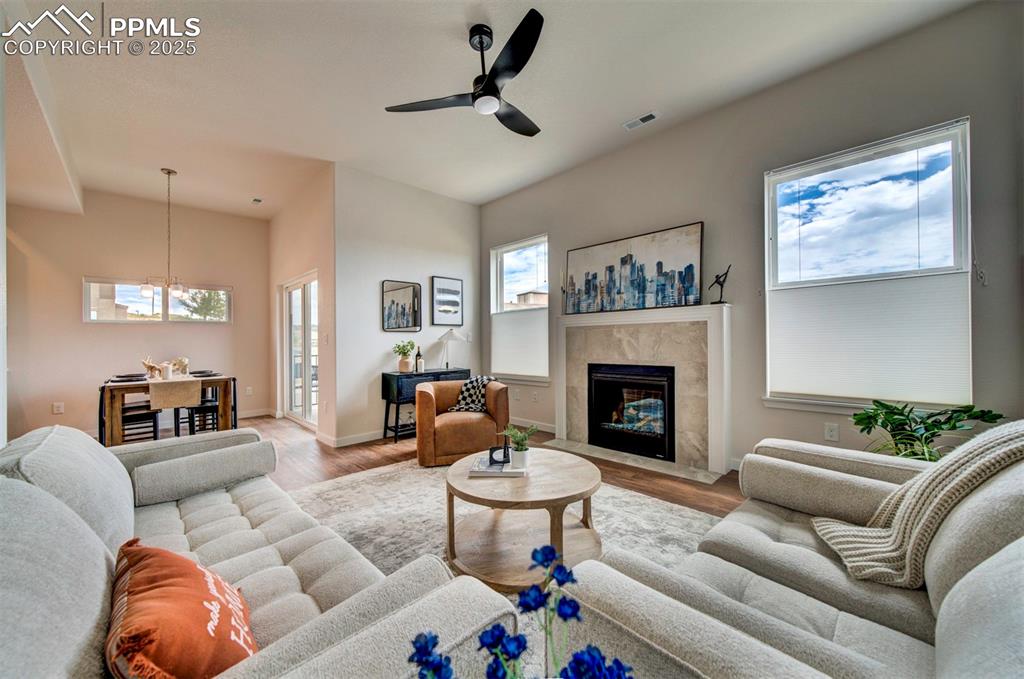 Image 17 of 42: Fireplace in living room is standard for cozy evenings in the winter.