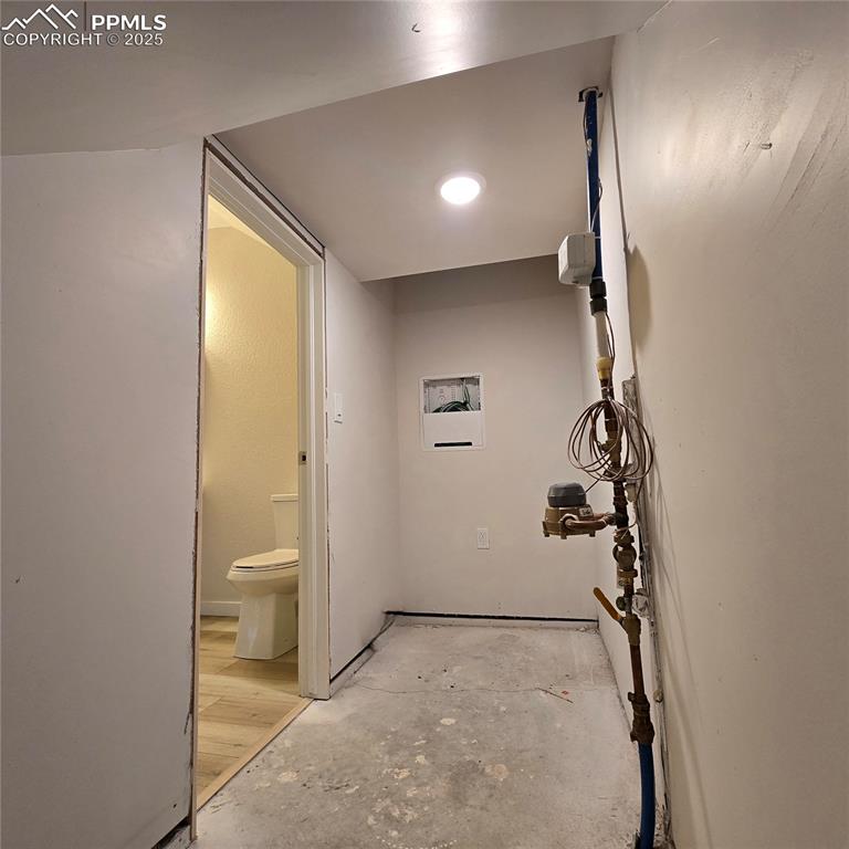 Image 21 of 42: Under-stairs storage is accessed from the powder room.