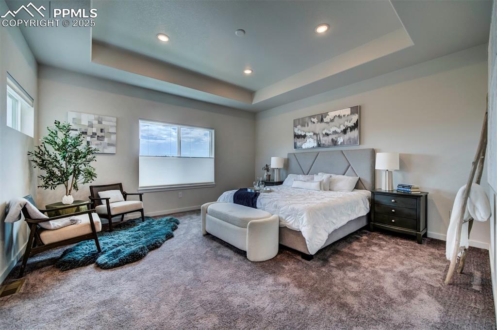 Image 26 of 42: Primary bedroom is large enough for a king bed and sitting area with room l