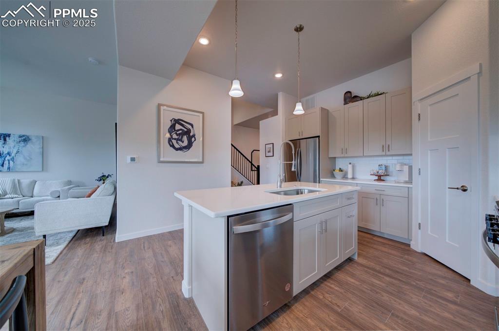 Image 3 of 42: Looking from the kitchen back towards the entry and stairs.