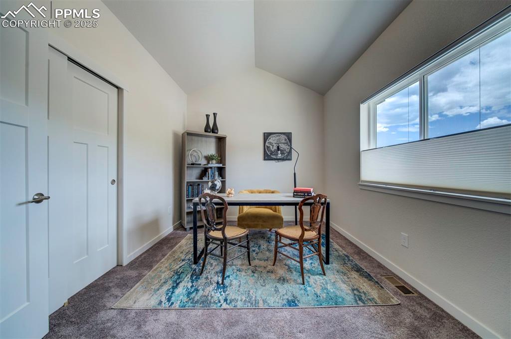 Image 33 of 42: Bedroom two has vaulted ceilings.