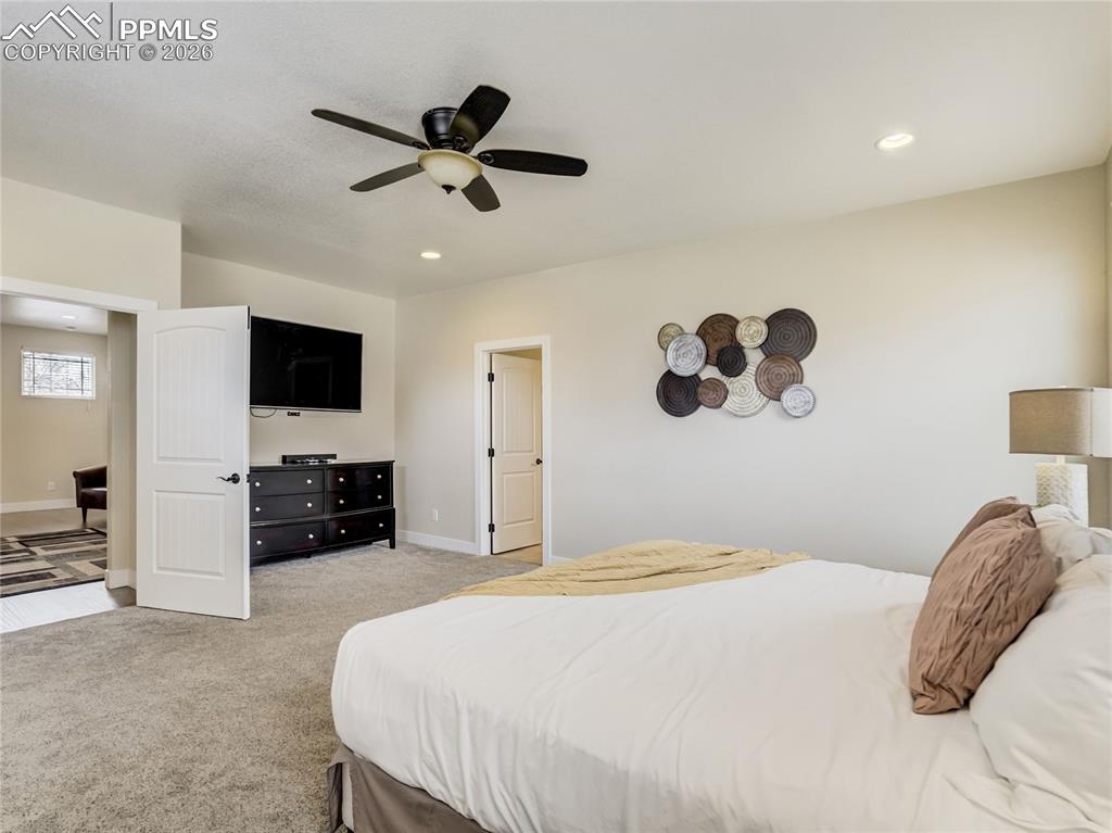 Image 27 of 47: The primary bedroom is accessed through the loft space by French Doors.
