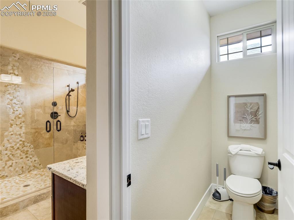 Image 30 of 47: The primary bathroom has a private water closet.